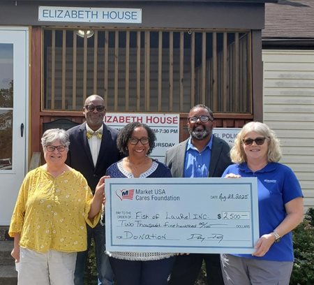 Group of people holding large gift check to Elizabeth House